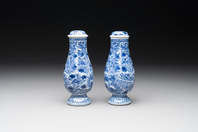 A pair of Chinese blue and white jugs and covers with floral design, Kangxi