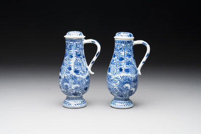 A pair of Chinese blue and white jugs and covers with floral design, Kangxi