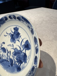 Two Chinese blue and white cups and saucers, Kangxi/Yongzheng