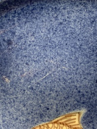 A Chinese blue, white and copper-red powder-blue-ground 'fish' dish, Kangxi