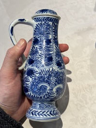 A pair of Chinese blue and white jugs and covers with floral design, Kangxi