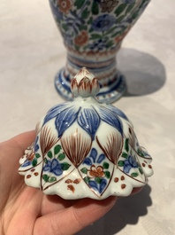 A pair of Chinese famille verte vases and covers with floral design, Kangxi