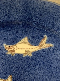 A Chinese blue, white and copper-red powder-blue-ground 'fish' dish, Kangxi