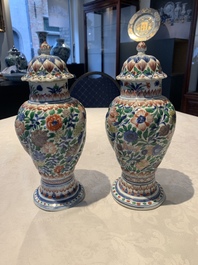 A pair of Chinese famille verte vases and covers with floral design, Kangxi