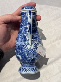 A pair of Chinese blue and white jugs and covers with floral design, Kangxi