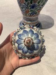 A pair of Chinese famille verte vases and covers with floral design, Kangxi