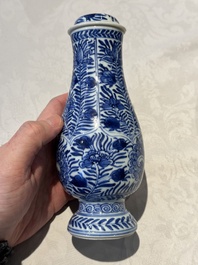 A pair of Chinese blue and white jugs and covers with floral design, Kangxi
