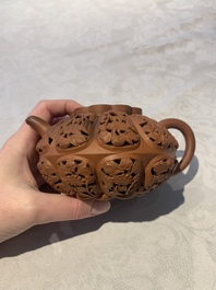A Chinese Yixing stoneware reticulated double-walled teapot and a teapot with floral relief design, Kangxi