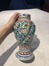 A pair of Chinese famille verte vases and covers with floral design, Kangxi