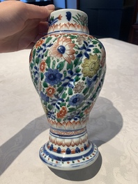 A pair of Chinese famille verte vases and covers with floral design, Kangxi