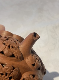 A Chinese Yixing stoneware reticulated double-walled teapot and a teapot with floral relief design, Kangxi