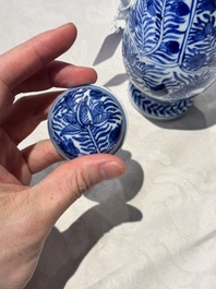 A pair of Chinese blue and white jugs and covers with floral design, Kangxi