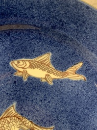 A Chinese blue, white and copper-red powder-blue-ground 'fish' dish, Kangxi