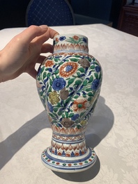 A pair of Chinese famille verte vases and covers with floral design, Kangxi