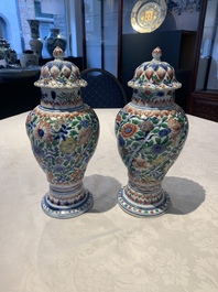 A pair of Chinese famille verte vases and covers with floral design, Kangxi
