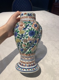 A pair of Chinese famille verte vases and covers with floral design, Kangxi
