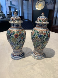 A pair of Chinese famille verte vases and covers with floral design, Kangxi