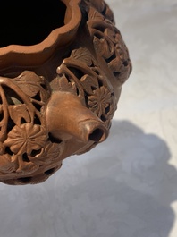 A Chinese Yixing stoneware reticulated double-walled teapot and a teapot with floral relief design, Kangxi