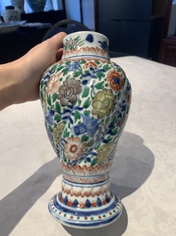 A pair of Chinese famille verte vases and covers with floral design, Kangxi