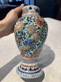 A pair of Chinese famille verte vases and covers with floral design, Kangxi