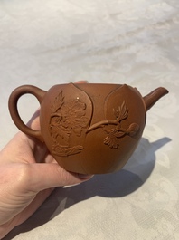 A Chinese Yixing stoneware reticulated double-walled teapot and a teapot with floral relief design, Kangxi