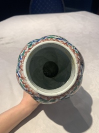 A pair of Chinese famille verte vases and covers with floral design, Kangxi