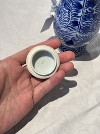 A pair of Chinese blue and white jugs and covers with floral design, Kangxi