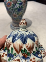 A pair of Chinese famille verte vases and covers with floral design, Kangxi
