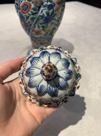 A pair of Chinese famille verte vases and covers with floral design, Kangxi