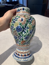 A pair of Chinese famille verte vases and covers with floral design, Kangxi