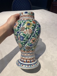 A pair of Chinese famille verte vases and covers with floral design, Kangxi
