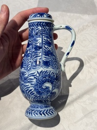A pair of Chinese blue and white jugs and covers with floral design, Kangxi