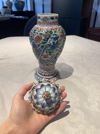A pair of Chinese famille verte vases and covers with floral design, Kangxi