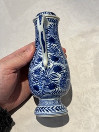 A pair of Chinese blue and white jugs and covers with floral design, Kangxi