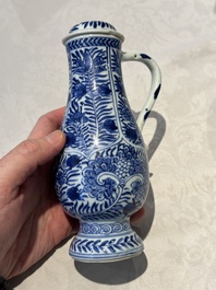 A pair of Chinese blue and white jugs and covers with floral design, Kangxi
