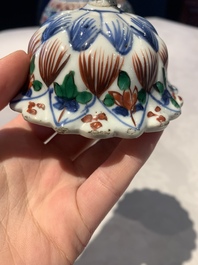 A pair of Chinese famille verte vases and covers with floral design, Kangxi