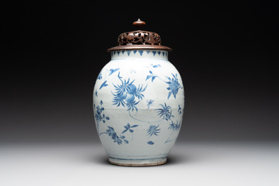 A Chinese blue and white vase with floral design and wooden cover, Transitional period