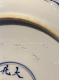A Chinese blue, white and copper-red powder-blue-ground 'fish' dish, Kangxi