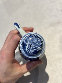 A pair of Chinese blue and white jugs and covers with floral design, Kangxi