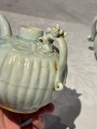 A pair of Chinese qingbai ewers and covers with dragon-form handles, Song/Yuan