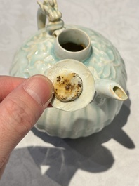 A pair of Chinese qingbai ewers and covers with dragon-form handles, Song/Yuan