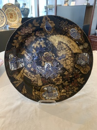 A Japanese-lacquered Chinese blue and white dish and a Japanese Kutani 'phoenix' dish, Wanli/19th C.