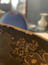 A Japanese-lacquered Chinese blue and white dish and a Japanese Kutani 'phoenix' dish, Wanli/19th C.