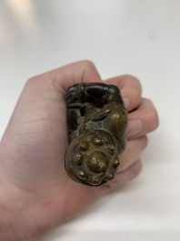 A small Chinese gilt bronze paperweight in the form of a kneeling foreigner, Ming