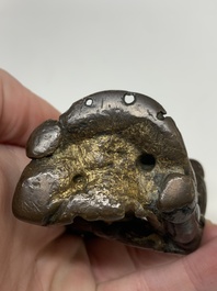 A small Chinese gilt bronze paperweight in the form of a kneeling foreigner, Ming