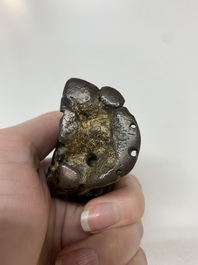 A small Chinese gilt bronze paperweight in the form of a kneeling foreigner, Ming