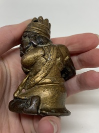 A small Chinese gilt bronze paperweight in the form of a kneeling foreigner, Ming