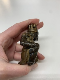 A small Chinese gilt bronze paperweight in the form of a kneeling foreigner, Ming