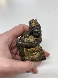 A small Chinese gilt bronze paperweight in the form of a kneeling foreigner, Ming