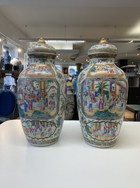 A pair of Chinese Canton famille rose vases and covers with narrative design, 19th C.